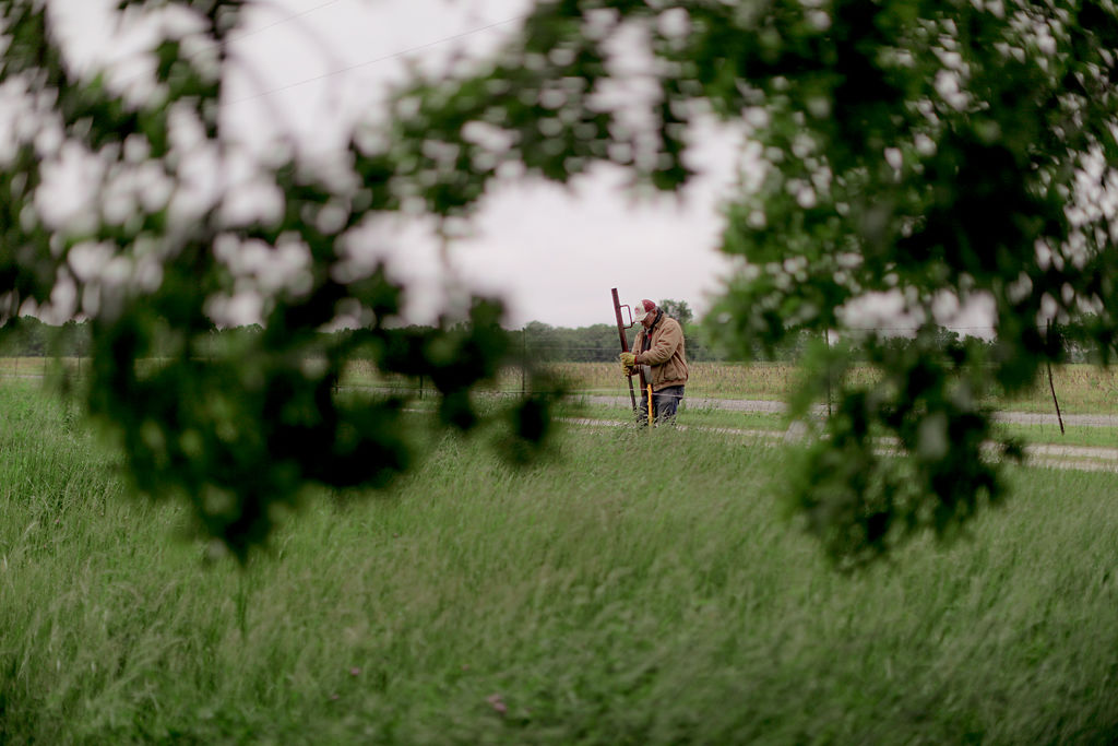 After a few consecutive days of rain, Steve Landers installs an electric fence